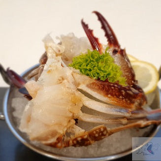Dish of crab legs on ice with lemon and garnish, branded 'Seafood Bazaar'.